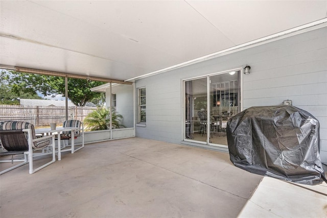 view of patio / terrace with fence and a grill