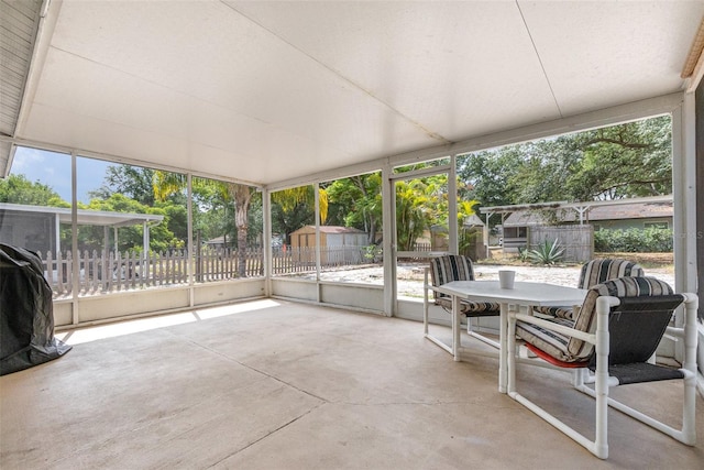 sunroom featuring outdoor dining area