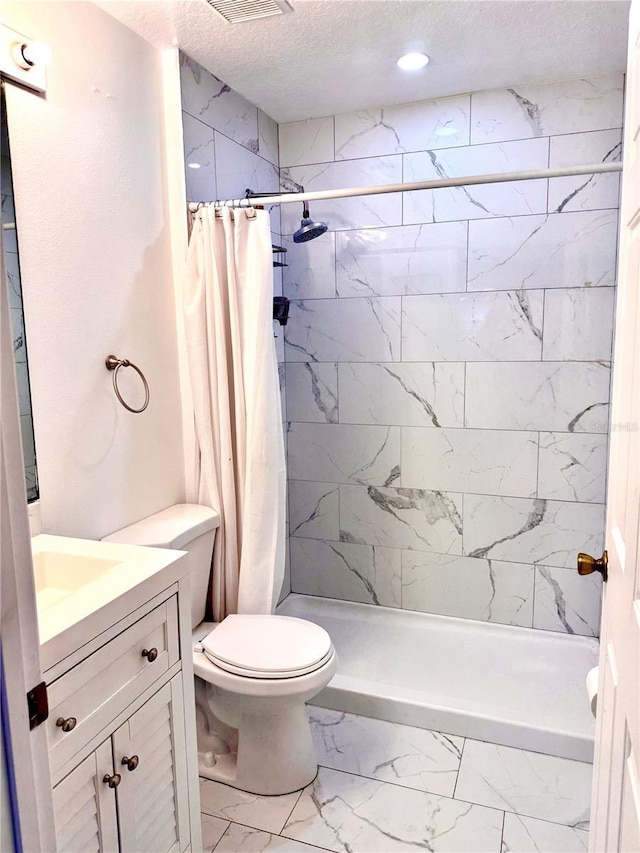 bathroom with vanity, toilet, a textured ceiling, marble finish floor, and a shower stall