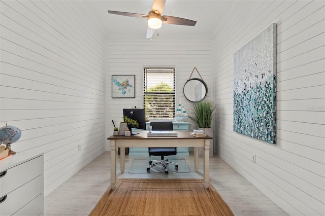 office space with wood walls and ornamental molding