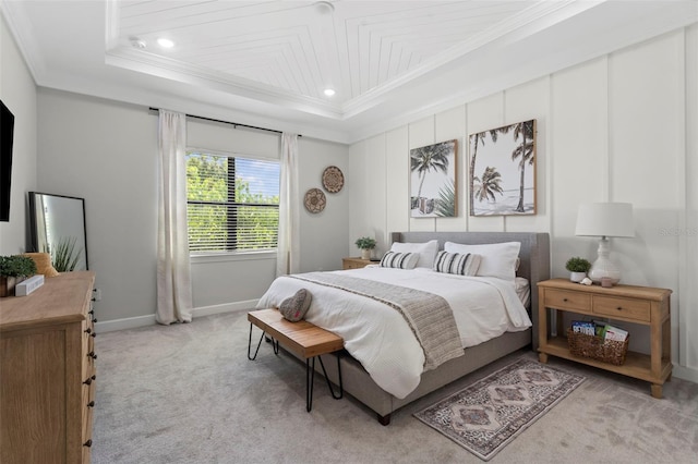 bedroom featuring light colored carpet, ornamental molding, baseboards, and a raised ceiling