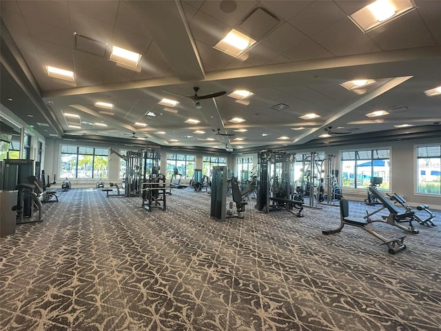 gym featuring carpet flooring, ceiling fan, and a wealth of natural light