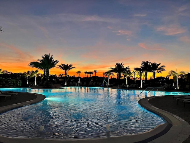 pool at dusk with a community pool