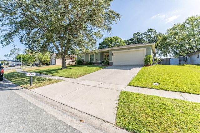 ranch-style house with a garage, driveway, a front lawn, and stucco siding