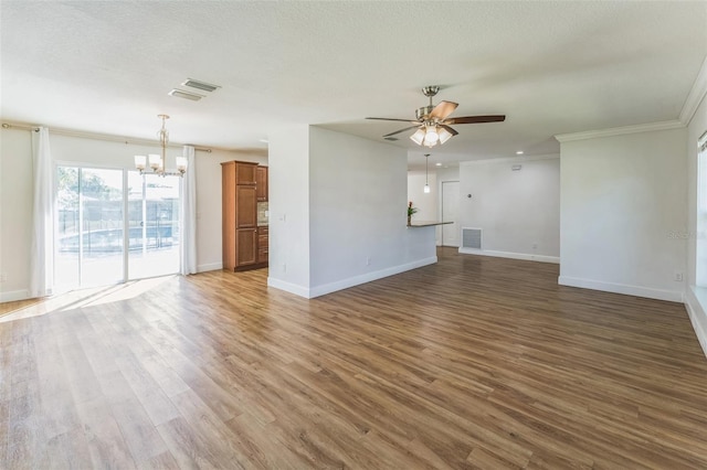 unfurnished living room with a chandelier, baseboards, a ceiling fan, wood finished floors, and ornamental molding
