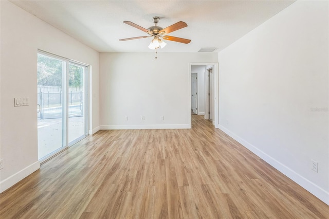 spare room with light wood finished floors, ceiling fan, and baseboards
