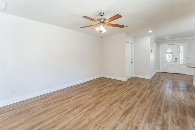 unfurnished living room featuring light wood-style flooring, ceiling fan, baseboards, ornamental molding, and recessed lighting