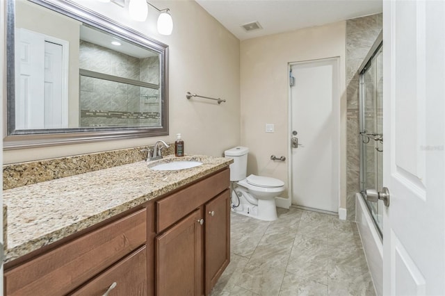 full bath with toilet, vanity, and enclosed tub / shower combo