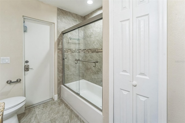 bathroom with toilet, a closet, and enclosed tub / shower combo