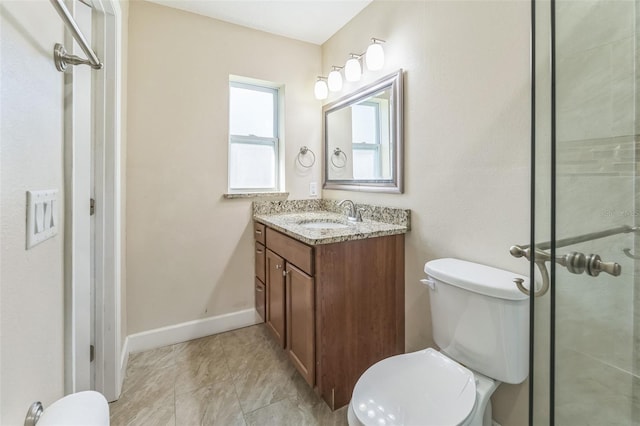 full bath with toilet, tiled shower, vanity, and baseboards