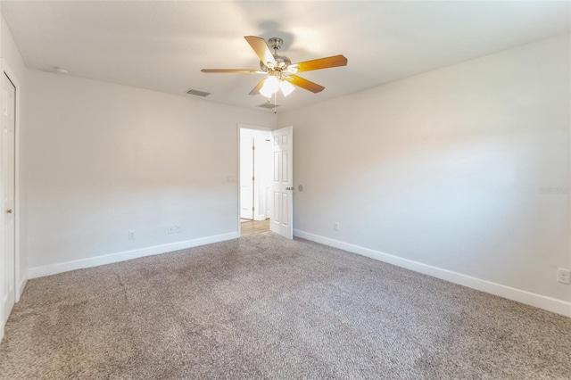 carpeted empty room with baseboards and ceiling fan