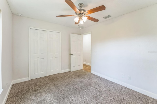 unfurnished bedroom with carpet, baseboards, a closet, and ceiling fan