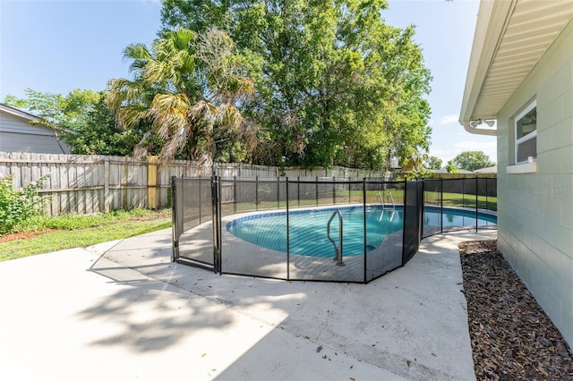 view of pool with a fenced backyard and a patio