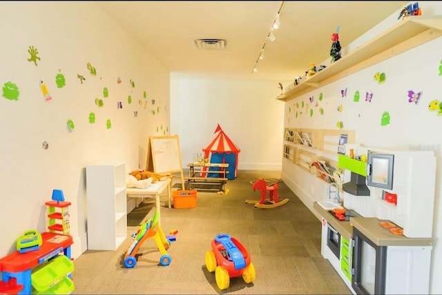 5245 W Irlo Bronson Memorial Hwy Unit 194, Kissimmee, FL 34746 - recreation room featuring visible vents, baseboards, and track lighting