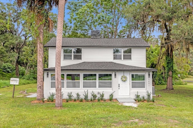 5851 SE Drew Rd, Belleview, FL 34420 - view of front of house featuring a shingled roof, a chimney, and a front yard