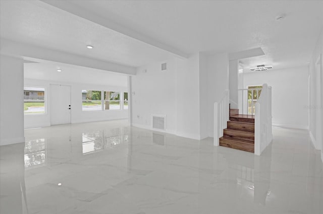 5851 SE Drew Rd, Belleview, FL 34420 - unfurnished room featuring visible vents, marble finish floor, stairs, and a healthy amount of sunlight