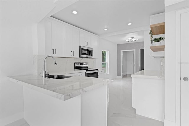 5851 SE Drew Rd, Belleview, FL 34420 - kitchen featuring recessed lighting, open shelves, appliances with stainless steel finishes, and a sink