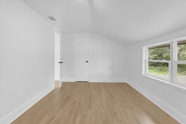 5851 SE Drew Rd, Belleview, FL 34420 - bonus room featuring baseboards, visible vents, lofted ceiling, and light wood-type flooring