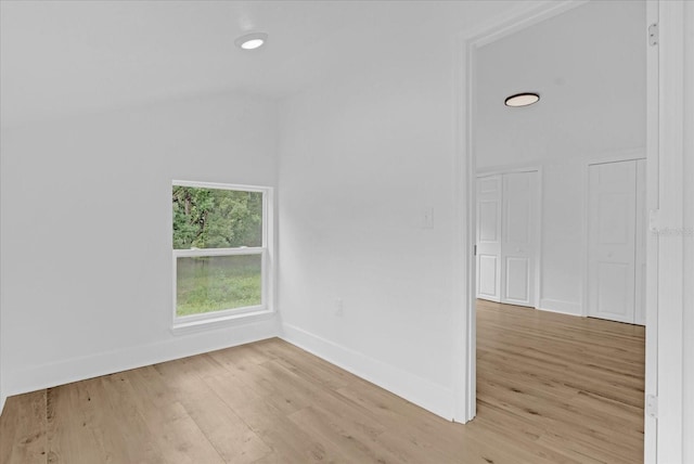 5851 SE Drew Rd, Belleview, FL 34420 - spare room with baseboards, lofted ceiling, and light wood-style floors