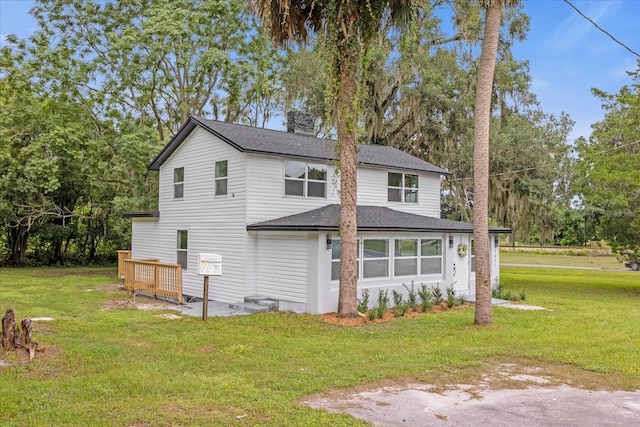 5851 SE Drew Rd, Belleview, FL 34420 - view of front of house featuring roof with shingles and a front lawn