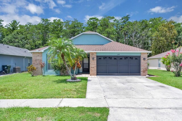 2398 Queenswood Cir, Kissimmee, FL 34743 - ranch-style home with a garage, brick siding, and a front yard