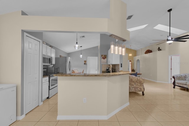 2398 Queenswood Cir, Kissimmee, FL 34743 - kitchen featuring stainless steel appliances, light tile patterned floors, open floor plan, light stone counters, and high vaulted ceiling