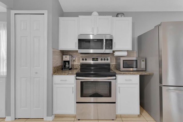 2398 Queenswood Cir, Kissimmee, FL 34743 - kitchen featuring stainless steel appliances, white cabinetry, decorative backsplash, and stone counters