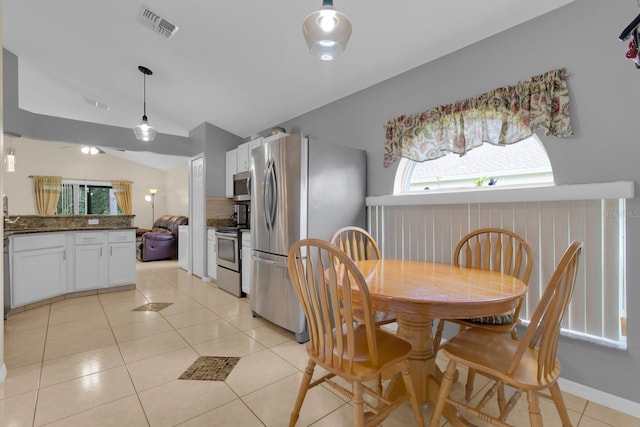 2398 Queenswood Cir, Kissimmee, FL 34743 - dining area featuring vaulted ceiling and light tile patterned floors