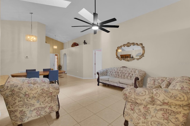 2398 Queenswood Cir, Kissimmee, FL 34743 - living room featuring high vaulted ceiling, a skylight, ceiling fan, light tile patterned floors, and a chandelier