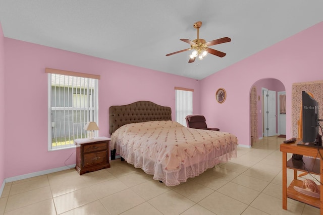 2398 Queenswood Cir, Kissimmee, FL 34743 - bedroom with arched walkways, light tile patterned floors, vaulted ceiling, and ceiling fan