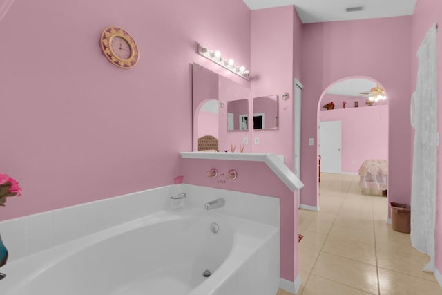 2398 Queenswood Cir, Kissimmee, FL 34743 - full bath with a bath, tile patterned floors, ensuite bathroom, and a ceiling fan
