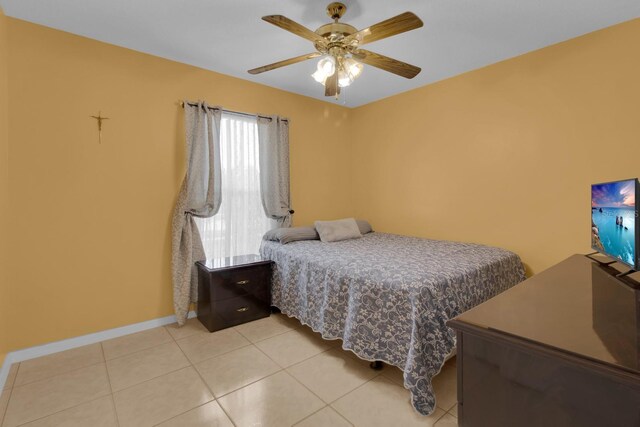 2398 Queenswood Cir, Kissimmee, FL 34743 - bedroom with light tile patterned floors and a ceiling fan