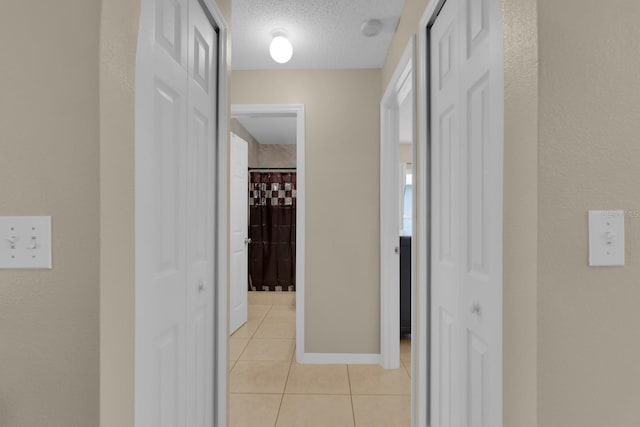 2398 Queenswood Cir, Kissimmee, FL 34743 - hall featuring light tile patterned floors and a textured ceiling