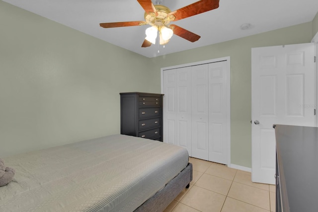 2398 Queenswood Cir, Kissimmee, FL 34743 - bedroom featuring light tile patterned flooring, a closet, and a ceiling fan