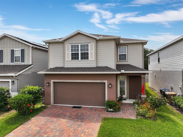 3084 Slough Creek Dr, Kissimmee, FL 34744 - traditional-style house with a garage, decorative driveway, a shingled roof, and central AC