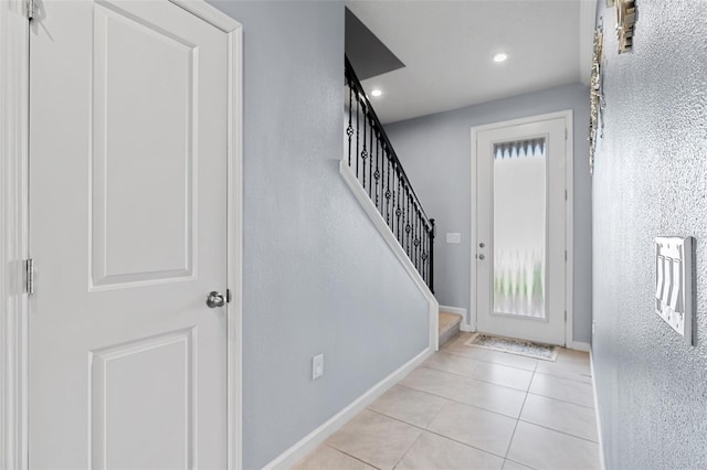 3084 Slough Creek Dr, Kissimmee, FL 34744 - tiled foyer with baseboards, stairs, a textured wall, and recessed lighting