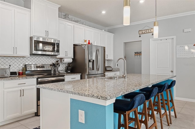 3084 Slough Creek Dr, Kissimmee, FL 34744 - kitchen featuring appliances with stainless steel finishes, a sink, light tile patterned flooring, tasteful backsplash, and ornamental molding