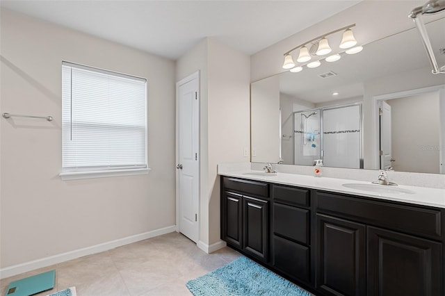 3084 Slough Creek Dr, Kissimmee, FL 34744 - full bathroom featuring a shower stall, double vanity, baseboards, and tile patterned floors