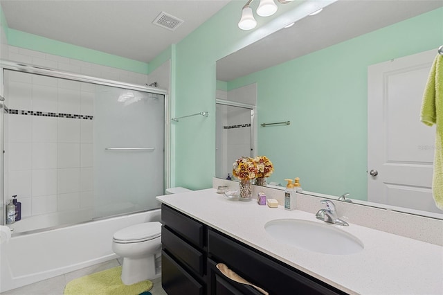 3084 Slough Creek Dr, Kissimmee, FL 34744 - bathroom with tile patterned floors, toilet, vanity, and shower / bath combination with glass door