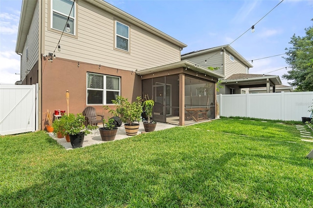 3084 Slough Creek Dr, Kissimmee, FL 34744 - back of property with a sunroom, stucco siding, and a patio area