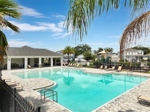 3084 Slough Creek Dr, Kissimmee, FL 34744 - community pool with fence, a patio, and a residential view