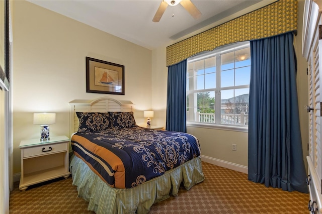 carpeted bedroom with baseboards and a ceiling fan