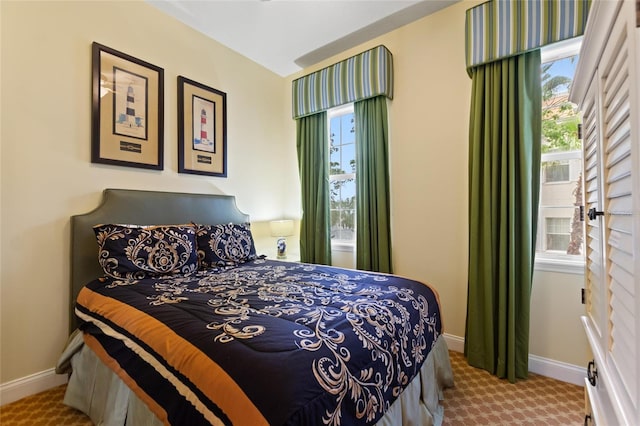 bedroom with carpet flooring and baseboards