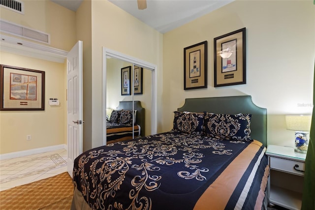 bedroom with a closet, baseboards, and a ceiling fan