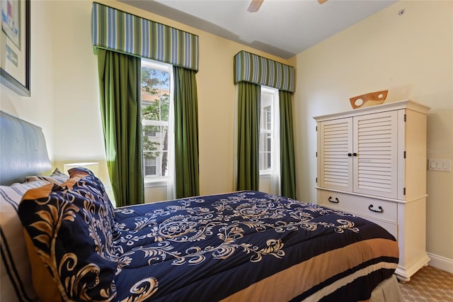 carpeted bedroom with baseboards and ceiling fan