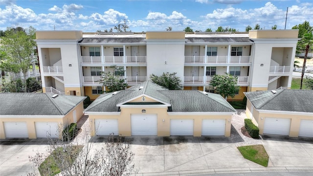 view of apartment building / complex with community garages