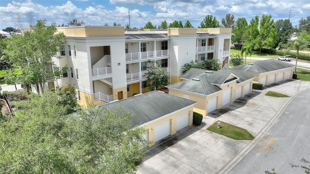 view of building exterior with community garages and concrete driveway
