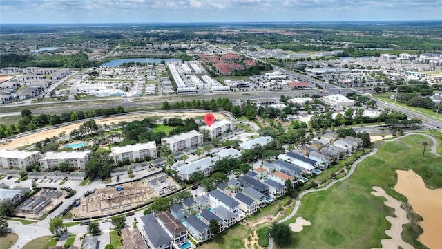 view of property location featuring a local golf course and a nearby body of water