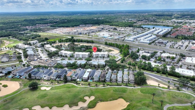view of property location featuring a local golf course and a nearby body of water