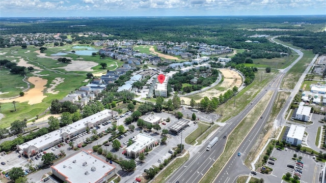 view of property location featuring a nearby body of water, a highway, and a golf course